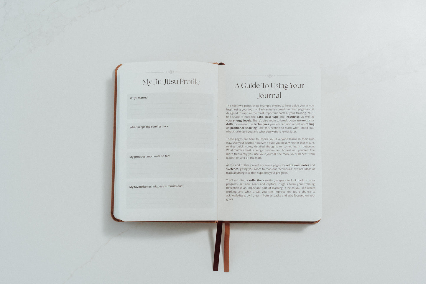 Open notebook with ivory pages and prompts to complete on a light grey background