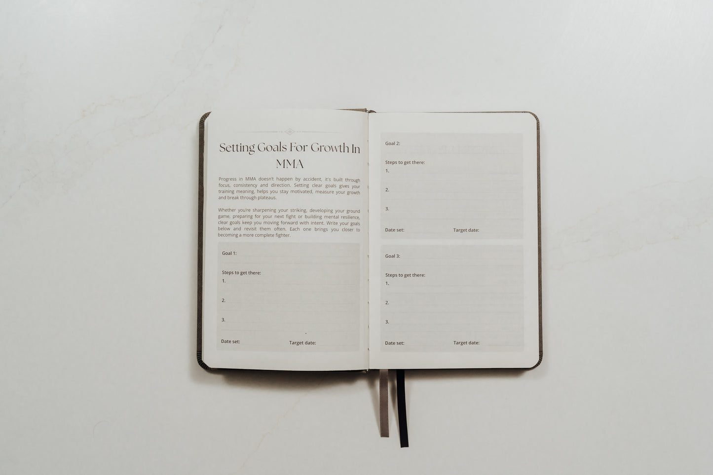 Open MMA training journal with structured note prompts on a white background