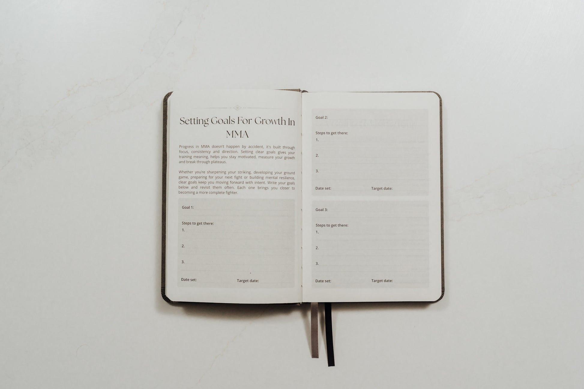 Open MMA training journal with structured note prompts on a white background