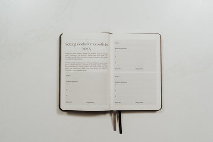 Open MMA training journal with structured note prompts on a white background