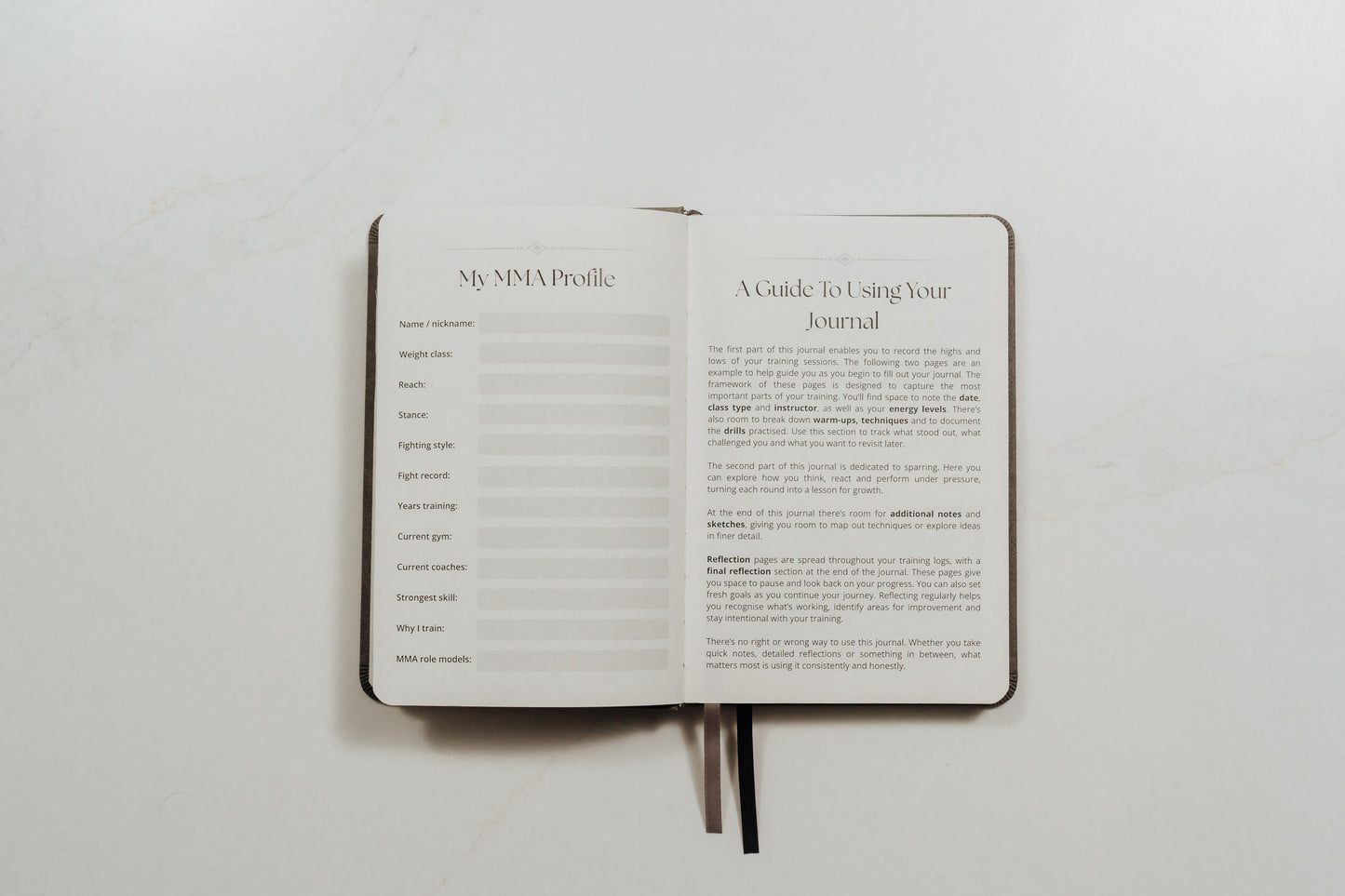 Open MMA training journal showing guided pages on a white background