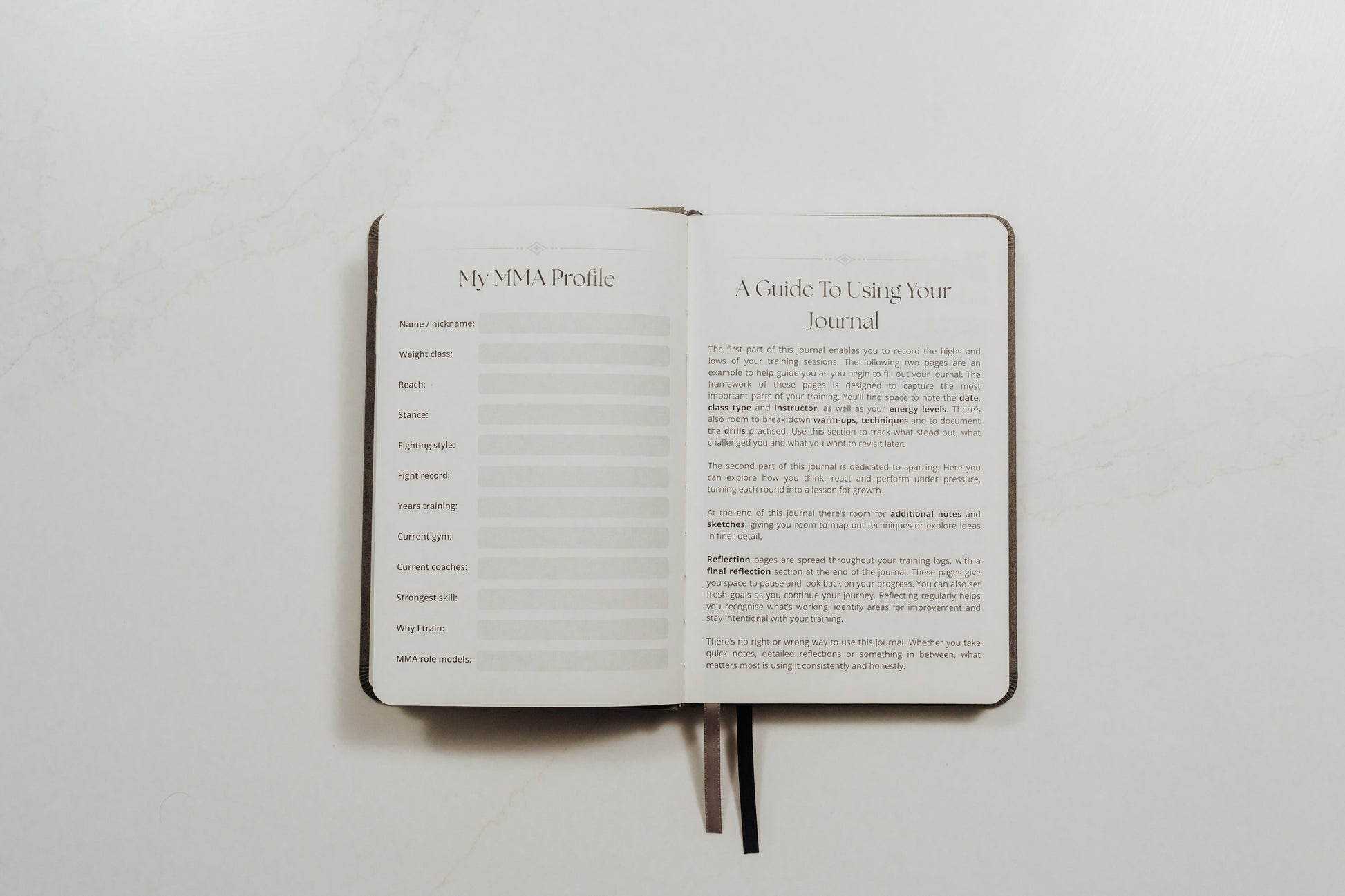 Open MMA training journal showing guided pages on a white background