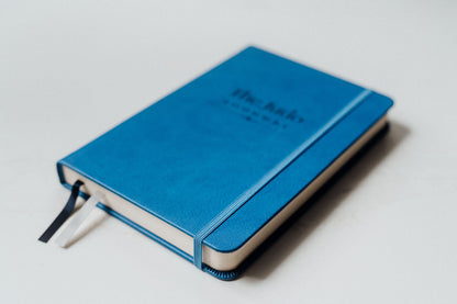Blue notebook on a light grey background