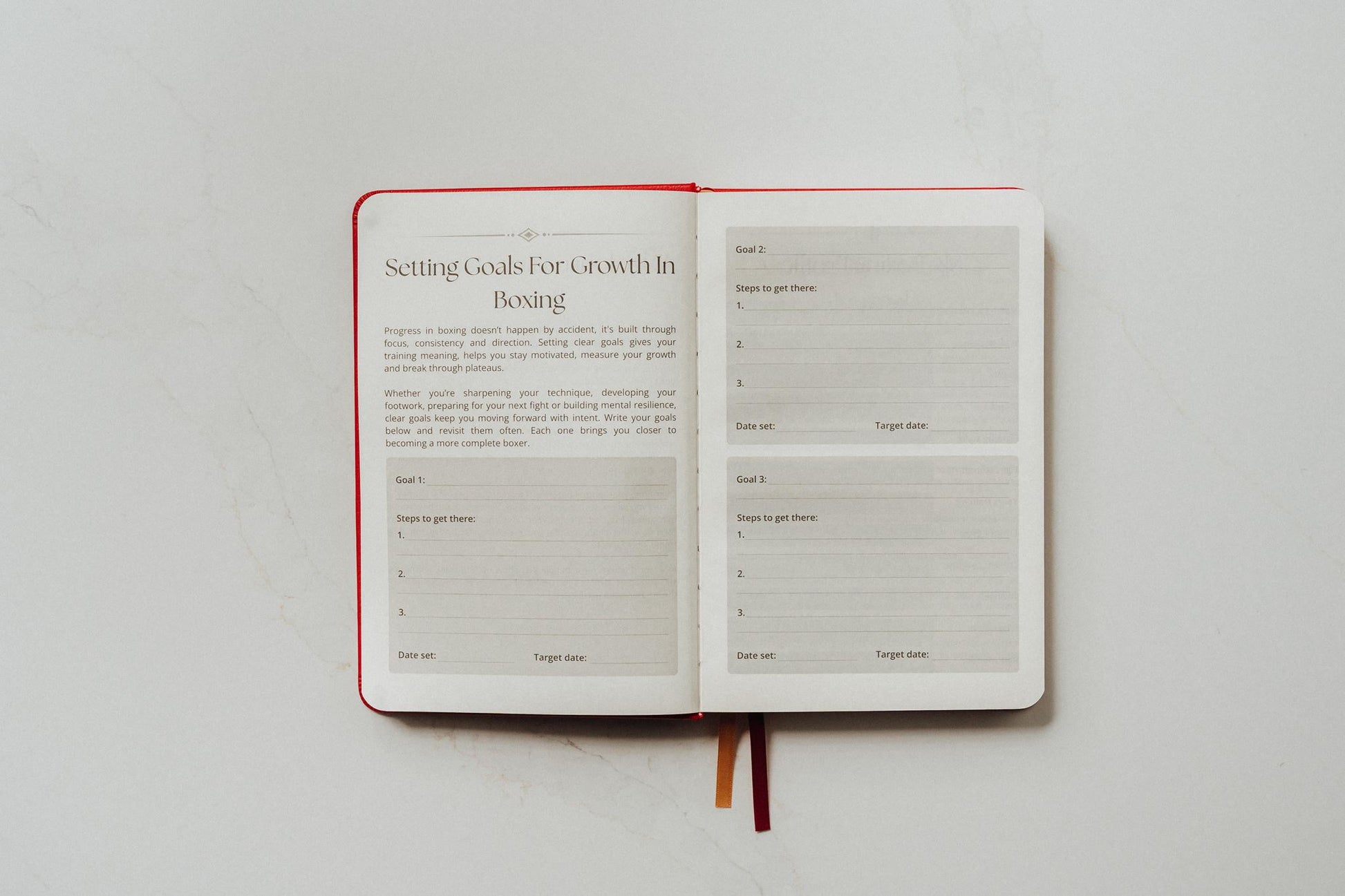 Open notebook with a page titled 'Setting Goals for Growth in Boxing' on a white background