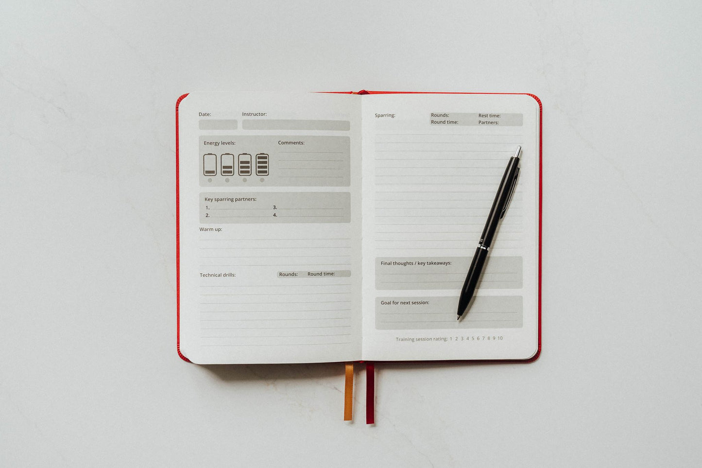 Open notebook with a pen on sparring main page a white background