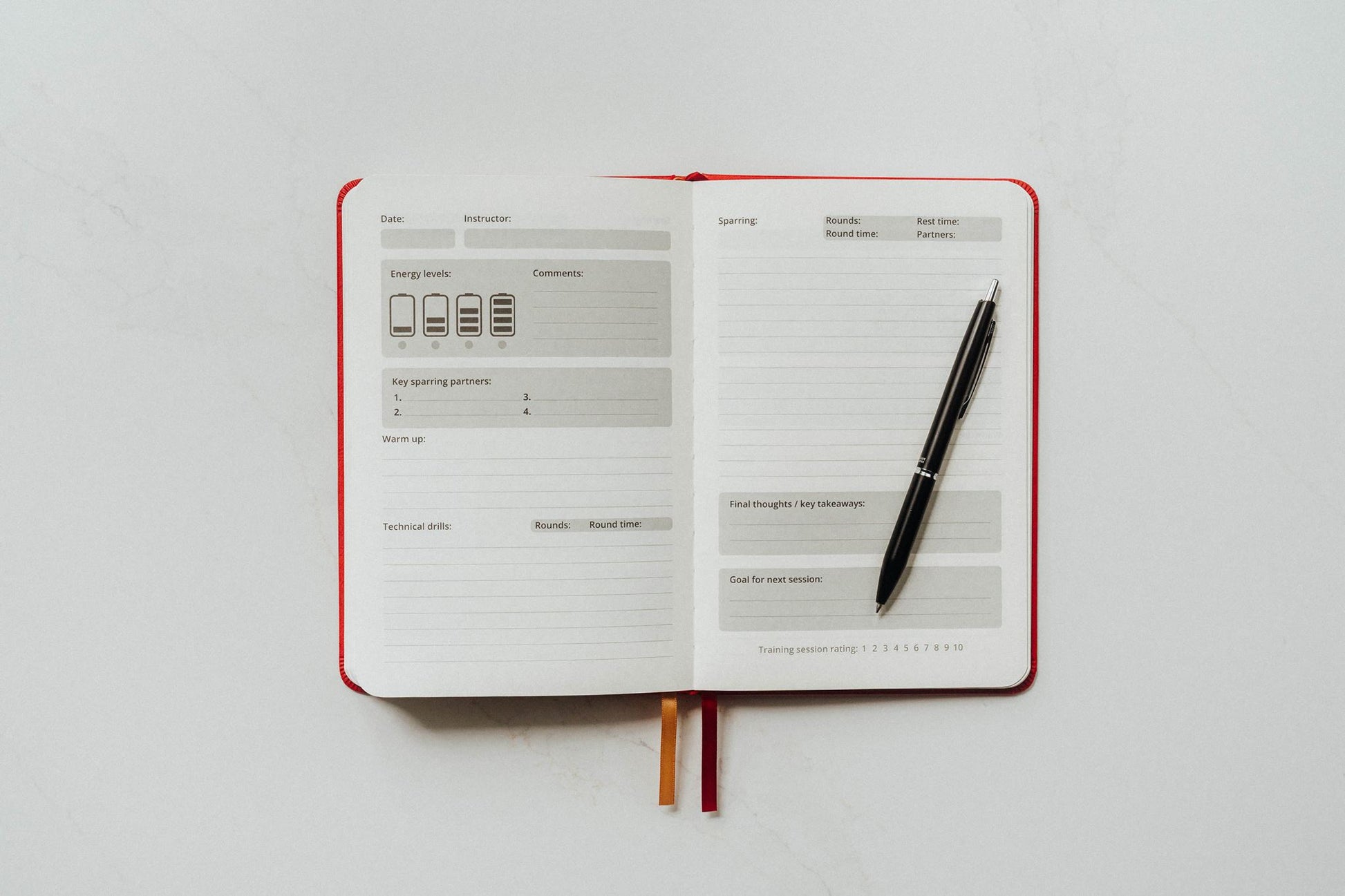 Open notebook with a pen on sparring main page a white background