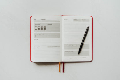 Open notebook with a pen on sparring main page a white background