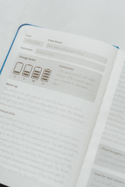 The Judo Journal open to an example page on a white background
