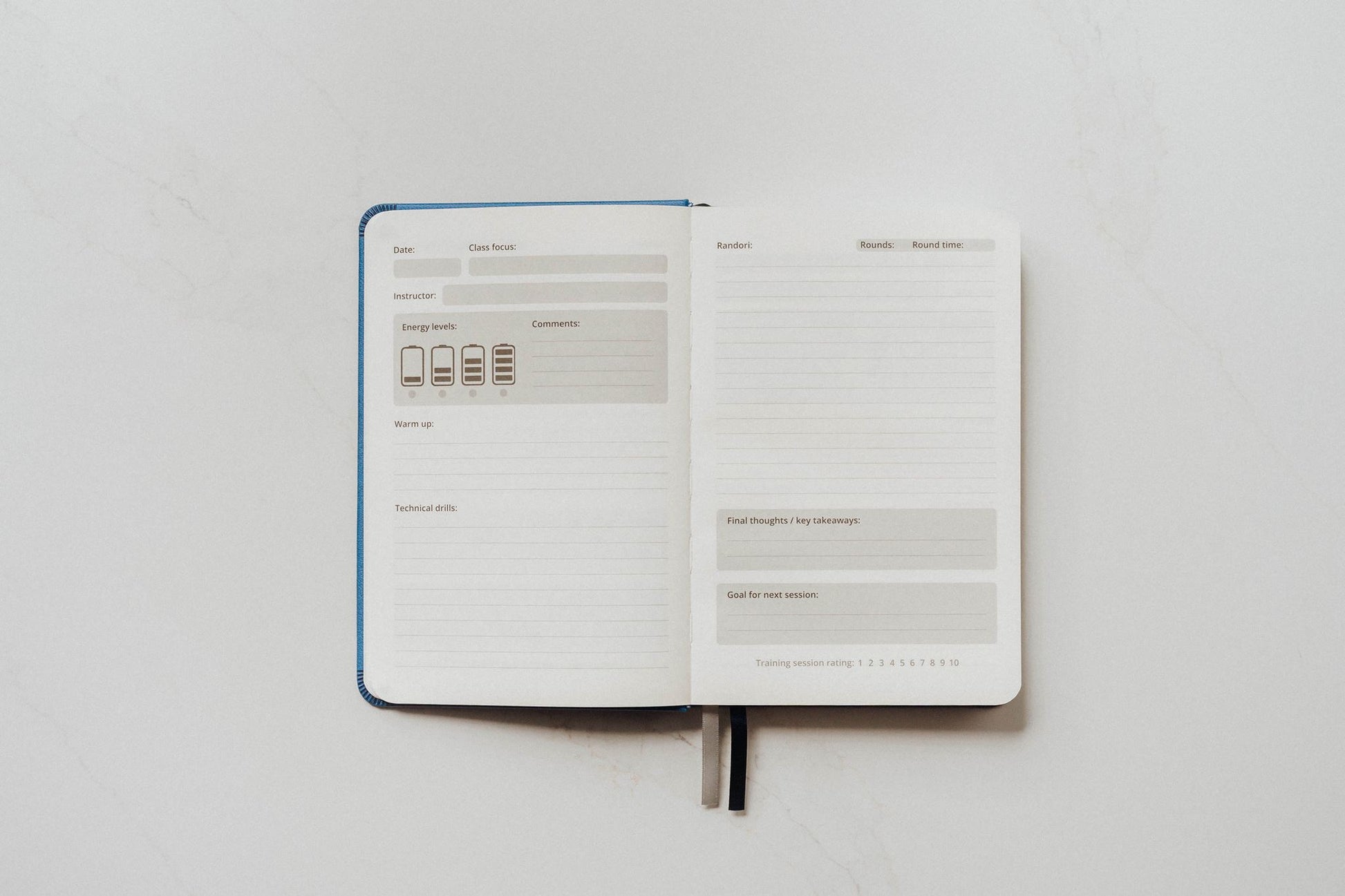 The Judo Journal open to show its guided prompt pages on a white background
