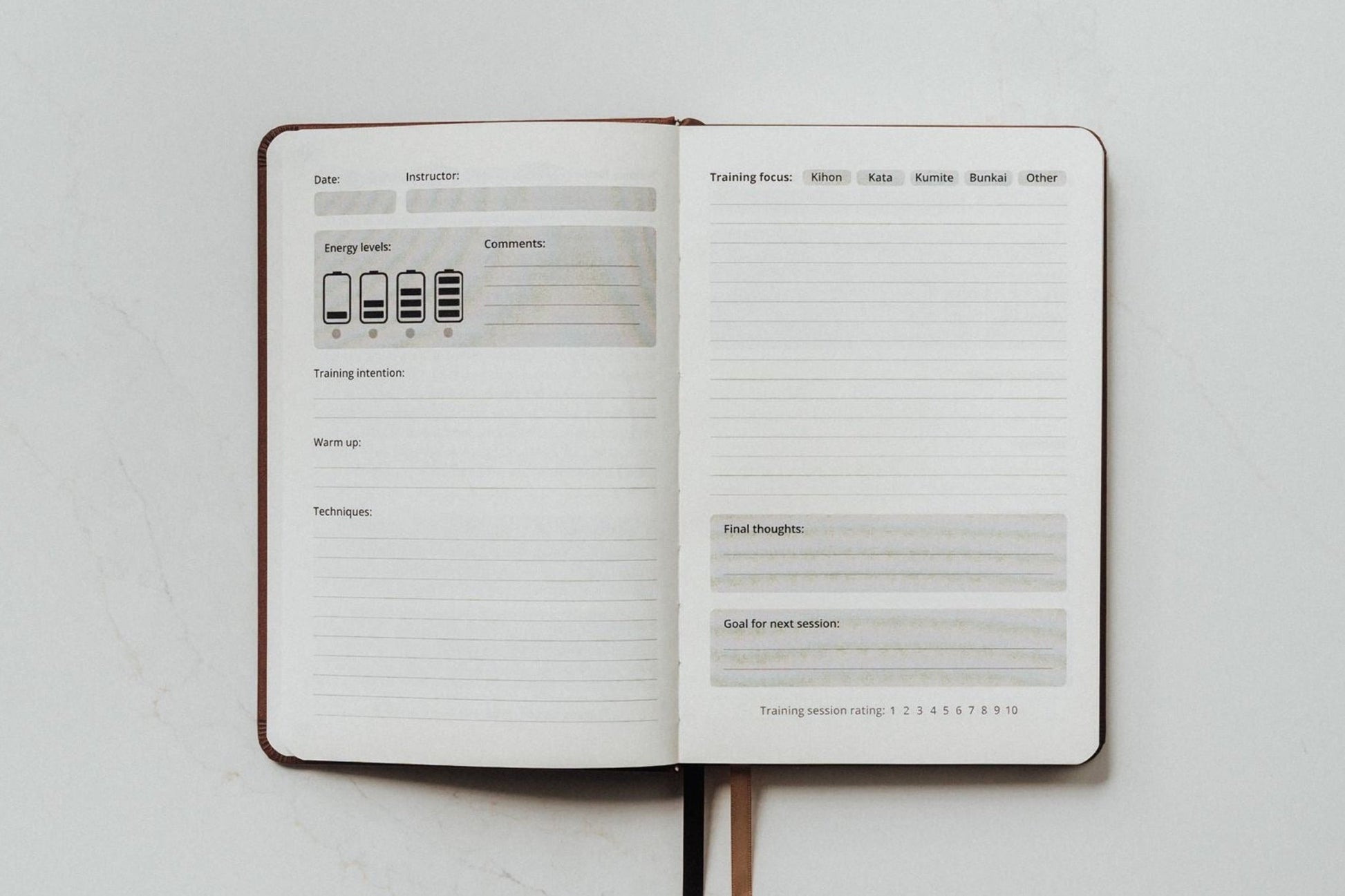 Open training log pages of The Karate Journal on ivory paper with prompts to fill out